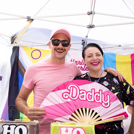 two people with a colourful fan
